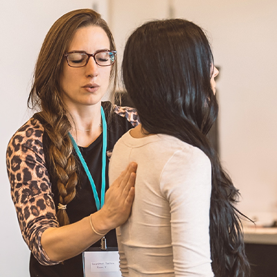 A somatic coach working hands-on with a client