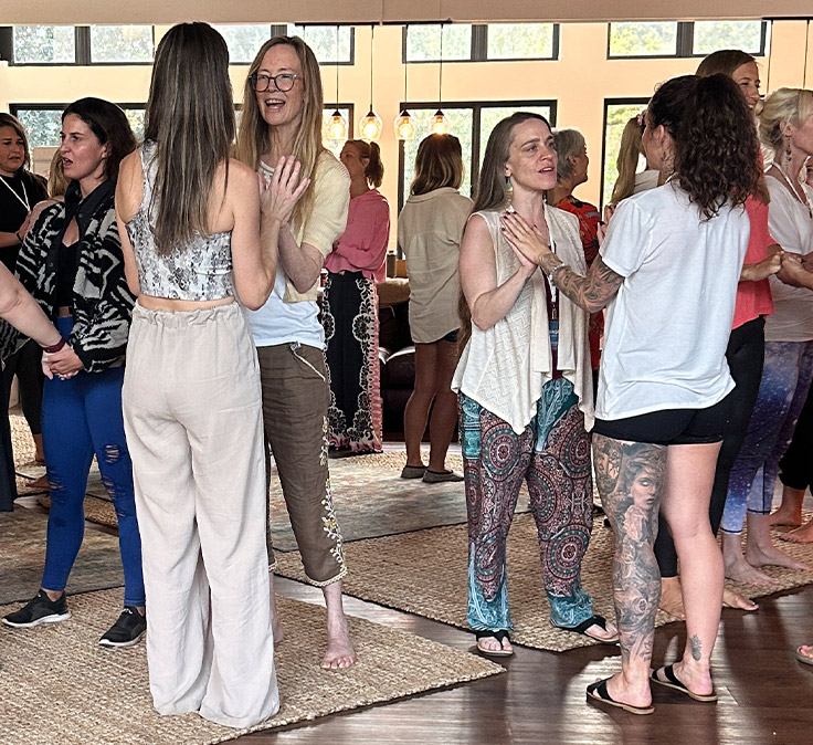 Group of students practising breathwork facilitation together in a live training room